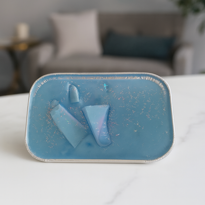 Blue wax cake on a white surface with a blurred background