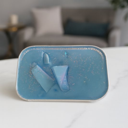 Blue wax cake on a white surface with a blurred background