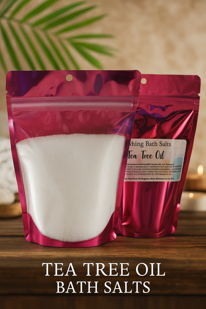 Two packages of tea tree oil bath salts on a wooden surface with a blurred background.
